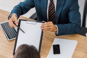 adult-smiling-insurance-agent-in-glasses-showing-c-2021-10-14-21-29-06-utc